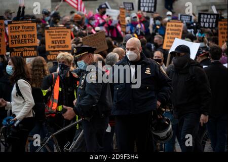 Manhattan, USA. 4th Nov, 2020. Policemen patrol protest for protecting election results on Fifth Avenue in front of the New York Public Library in Manhattan, USA. Credit: Micah Casella/Alamy Live News. Stock Photo