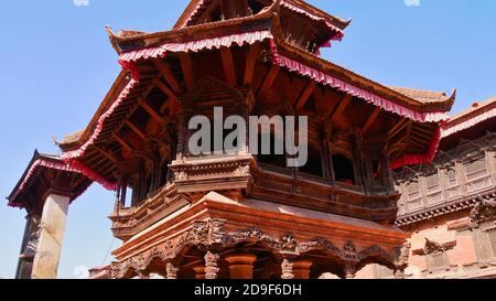 Top of a historic wooden temple (pagoda style) with beautiful ornaments and decorations located in Bhaktapur Durbar Square, Nepal. Stock Photo