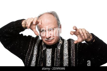 gesticulating offended elderly man with raised hands Stock Photo