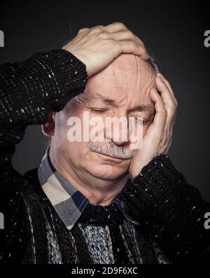 an older man suffering from a headache Stock Photo