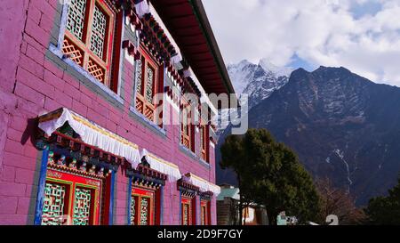 Beautiful multi-colored purple facade with colorful ornaments and windows of popular historic Buddhist Tengboche (Thyangboche) monastery (gompa). Stock Photo