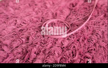 Textile background of withered rose color. Handcrafted airy texture and fine drawstring. Haute couture. Laksheri. Stock Photo