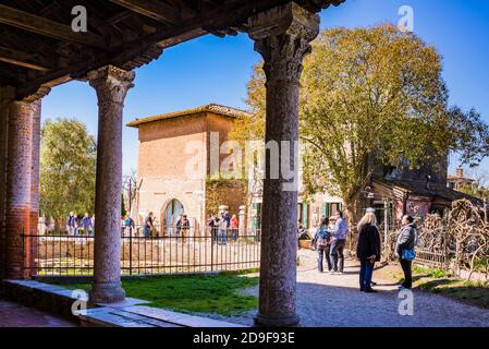 Main square seen from the covered walkway of church of Santa Fosca, Byzantine church on the island of Torcello. Torcello, Venetian Lagoon, Venice, Ven Stock Photo