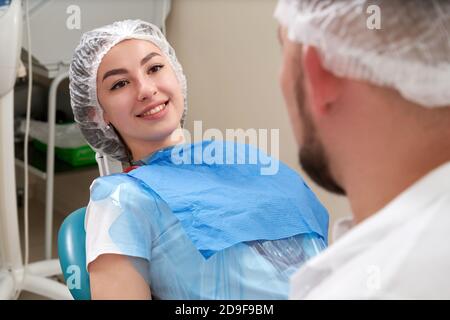 Woman patient at the dentist smiling and waiting to be checked up Stock Photo
