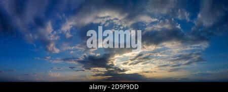 Panorama of dramatic twilight, sunset between clouds on the horizon. Stock Photo