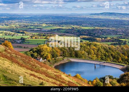 An autumn view of British Camp reservoir in the Malvern hills looking towards Bredon hill, Worcestershire, England Stock Photo