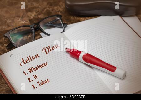 Action plan text on paper in open diary with glasses, colorful stationery pen on marble work table, business and finance concept Stock Photo