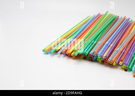 Multicoloured plastic straws on a white background with copy space. Celebration and party background Stock Photo