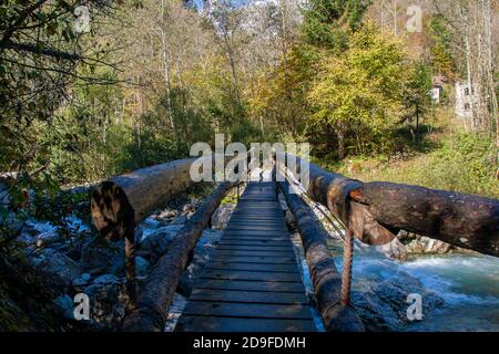 Bridge over the mountain stream in the middle of dolomites mountains in Italy Stock Photo