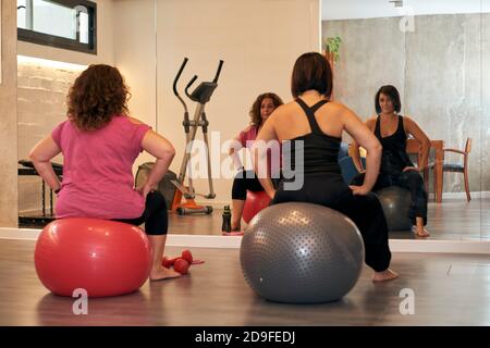 Two women working out with Pilates balls at home Stock Photo