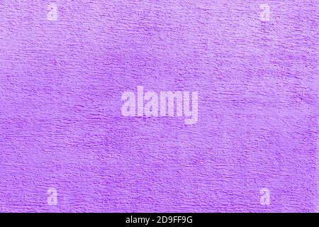 Texture of violet plaster. Interior of a modern loft. Abstract rough background. The facade of an old house. Stock Photo