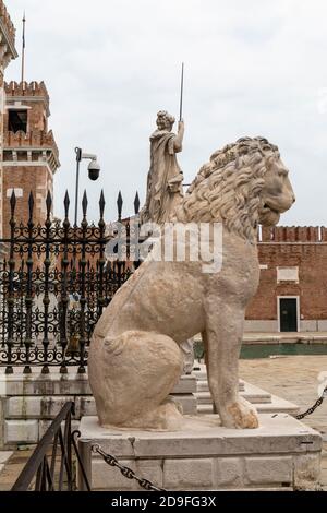 The famous marble Piraeus Lion statue an ancient Greek lion at the entrance to the Venetian Arsenal.  Venice, Italy Stock Photo