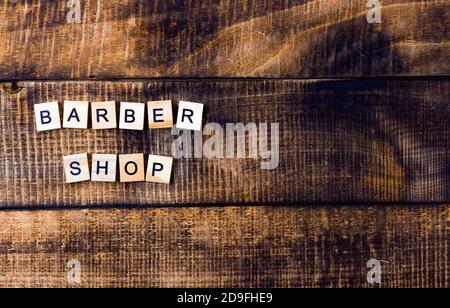 barbershop. inscription on a wooden background, located on the side. Stock Photo