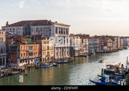 Aerial view of the Grand Canal bathed in evening sunlight from Hotel H10 bar balcony, Venice, Italy. Gondola moored near San Silvestro Vaporetto stop. Stock Photo