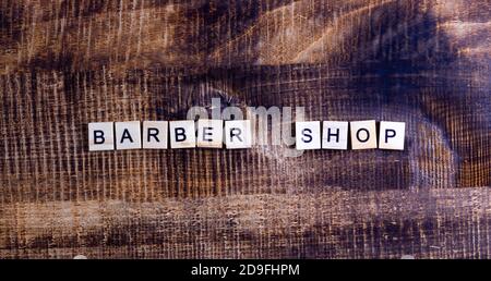 barbershop. lettering on a wooden background, centered horizontal orientation. Stock Photo