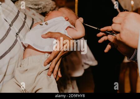 rite of sacrament of epiphany child baby in church Stock Photo