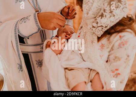 rite of sacrament of epiphany child baby in church Stock Photo