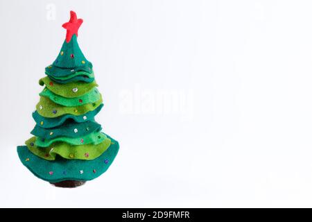 Green felt christmas tree with jingle bells against white background with copy space Stock Photo