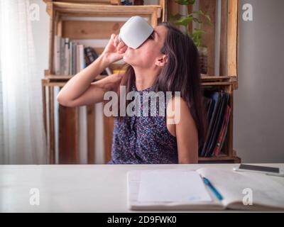 A Young Hispanic Woman Working in a Desk Stock Photo