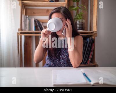 A Young Hispanic Woman Working in a Desk Stock Photo