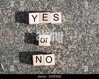 yes, no text on blue background. Yes No Balance concept on wooden blocks. Stock Photo