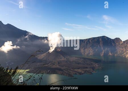 landscape with clouds in the morning, beautiful volcano Rinjani Gurung at Lombok Island, Indonesia. Small lake in the mountains, soft focus Stock Photo