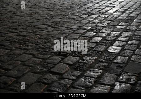 Granite paving stones on the pavement at night. Stock Photo