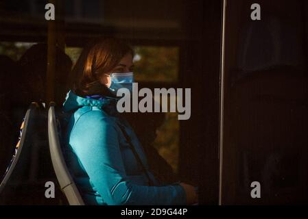 RIGA, LATVIA. 13th October 2020. Woman wearing face protective mask at bus. Stock Photo