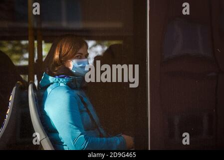 RIGA, LATVIA. 13th October 2020. Woman wearing face protective mask at bus. Stock Photo