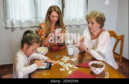 Three female generations using tablet and smartphone Stock Photo