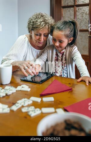 Grandmother and granddaughter playing with tablet Stock Photo