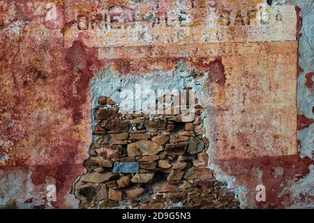 Grunge brick wall with space for text. Old abandoned house with old crumbling plaster ceiling. Stock Photo