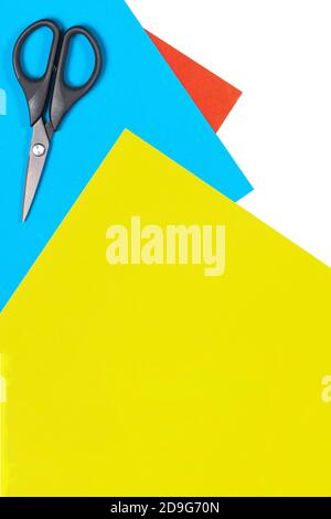 Colorful paper sheets and scissors on white table. Top view, copy space Stock Photo