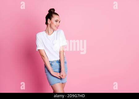 Photo of charming nice adorable lady funny pretty bun summer vacation good mood look shy empty space wear white t-shirt jeans blue mini skirt isolated Stock Photo