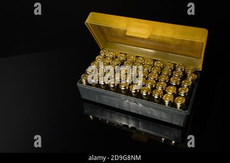 Closeup of a box of 9 mm ammunition on a dark background. 9 mm rounds. Stock Photo