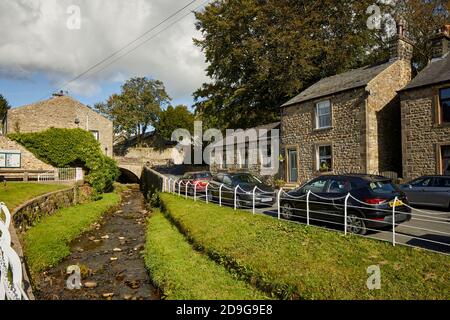 Branch road in Waddington, Lancashire with Waddington Brook Stock Photo