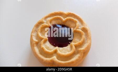 Round cookies with blueberry filling, isolated on light background Stock Photo