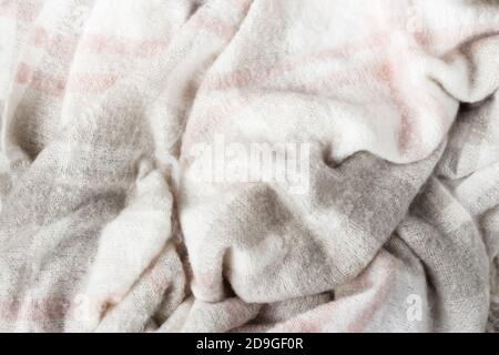 Crumpled gray wool blanket. Soft and warm fabric crumpled in folds. Autumn or winter vibe texture Stock Photo