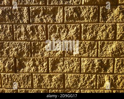 Wall, Textured, Abstracts, Backgrounds. Photograph of a textured yellow wall. Natural light. In Brazil it is known as a roughcast wall. Stock Photo