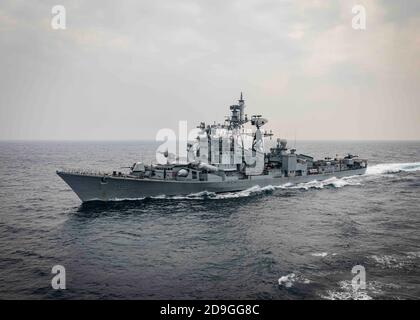 The Indian navy Rajput-class guided-missile destroyer INS Ranvijay sails alongside the Arleigh Burke-class guided-missile destroyer USS John S. McCain during exercise Malabar 2020 November 3, 2020 in the Indian Ocean. Stock Photo