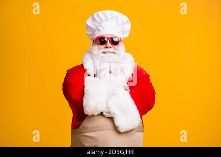 Photo of santa claus in chef culinary headwear cross hands cook x-mas christmas noel meal wear apron sunglass isolated over bright shine color Stock Photo