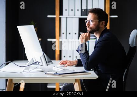 Employee Using Business Computer. Work From Home Stock Photo