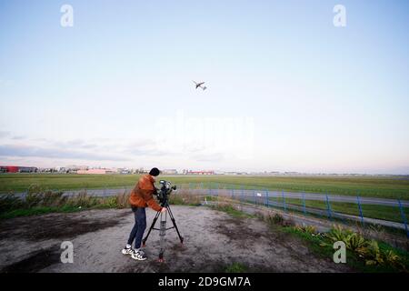 A cameraman films a LOT airliner taking off from Chopin International Airport in Warsaw, Poland on November 5, 2020. The Polish government has approve Stock Photo