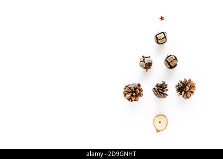 Creative winter alternative christmas tree layout made with pine cones. Flat lay, copy space. Holiday festive minimal concept Stock Photo