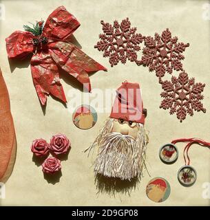 A flatlay of assorted Christmas decorations, ribbons, gift tags and bows. Stock Photo