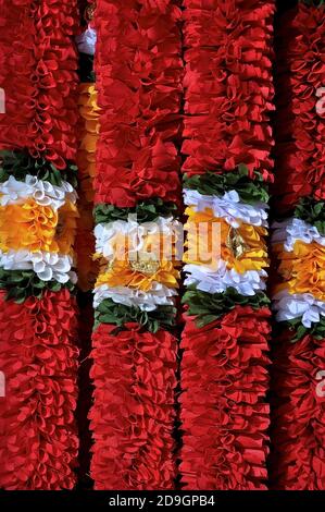 Brightly coloured garlands of red, white, green and orange, used as traditional decorations during the Hindu festival of Deepavali. Stock Photo