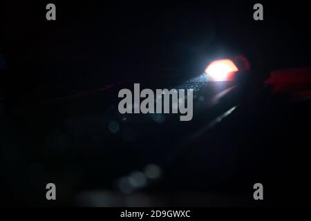 Flashlight lighten blurred dust in the dark. Stock Photo