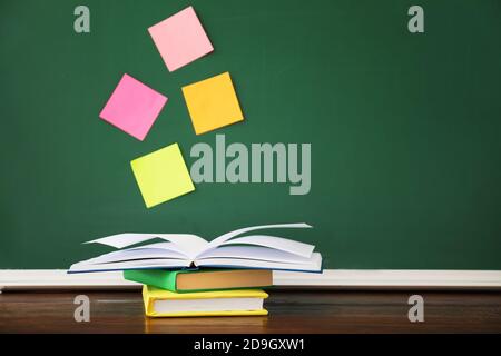 Stack of books on table in classroom Stock Photo