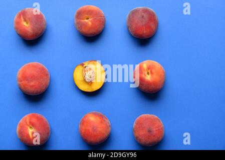 Sweet peaches on color background. Concept of uniqueness Stock Photo