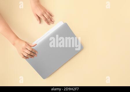 Female hands with modern laptop on color background Stock Photo